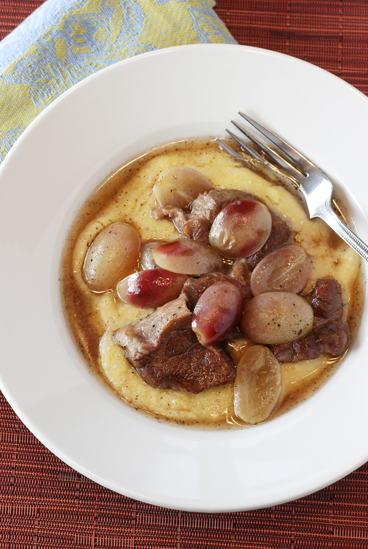 Plenty of plump red grapes along with juicy tender pork. All over soft polenta.