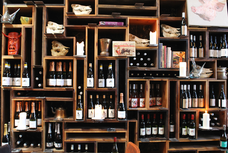 Shelves stocked with wine, and an eclectic assortment of colorful items.
