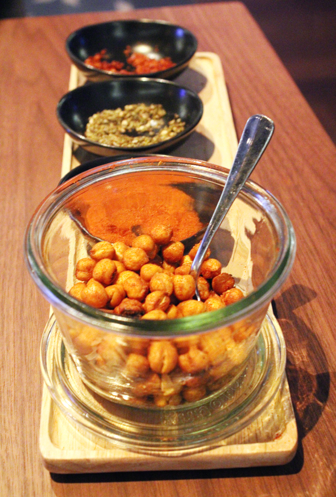 Fried chickpeas with bowls of spices to mix in.