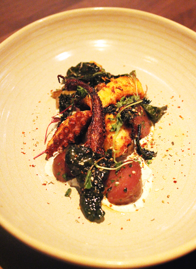 Octopus with fried kale leaves.