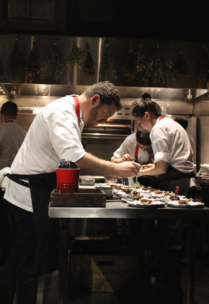 Chef David Barzelay putting the finishing touches on a dish at his Lazy Bear in San Francisco.