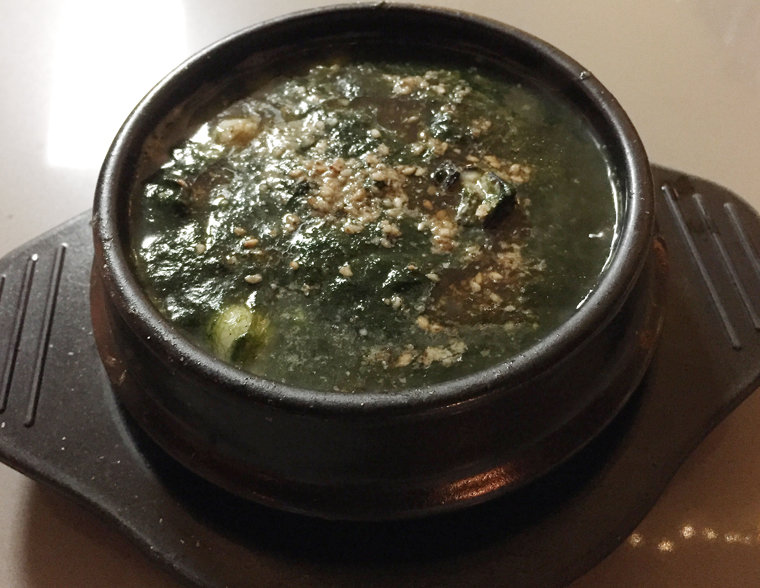Seaweed and oyster soup in an iron pot.