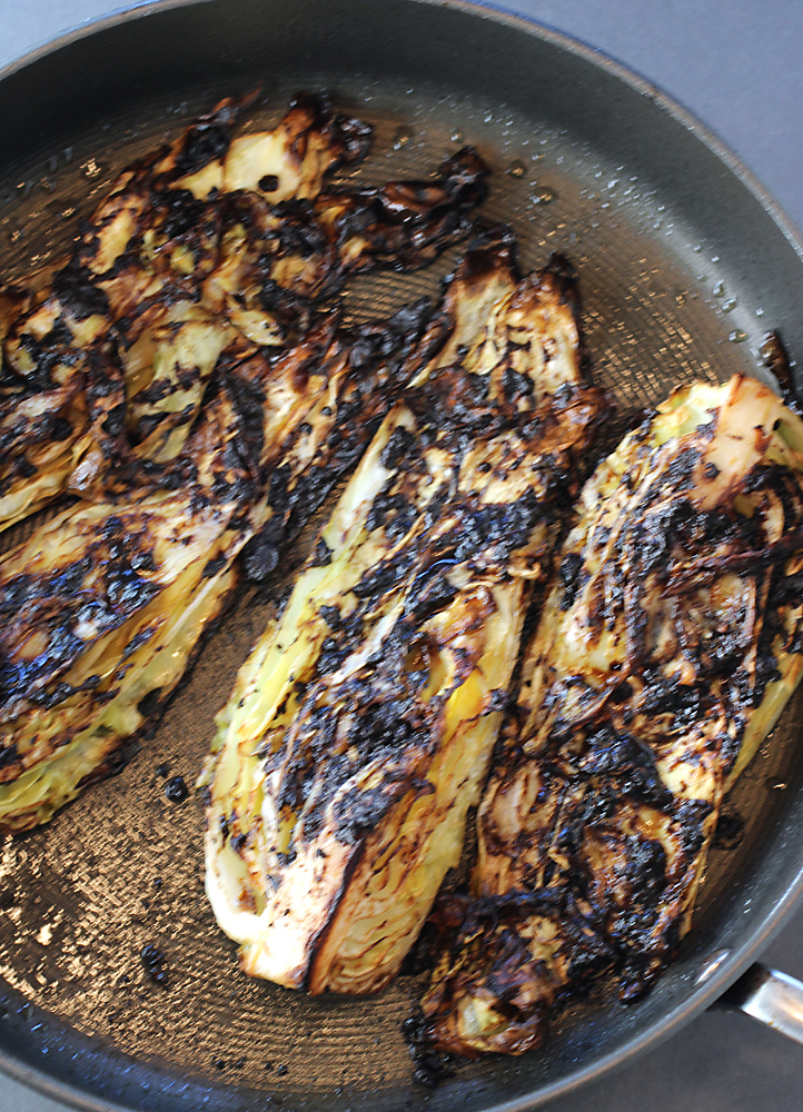 One large pan will hold a quartered arrowhead cabbage, but you will probably need two pans for one green cabbage.