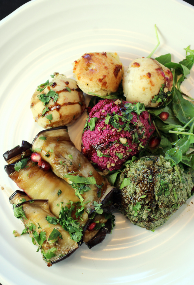 An appetizer of creamy walnut spreads and eggplant roll-ups.