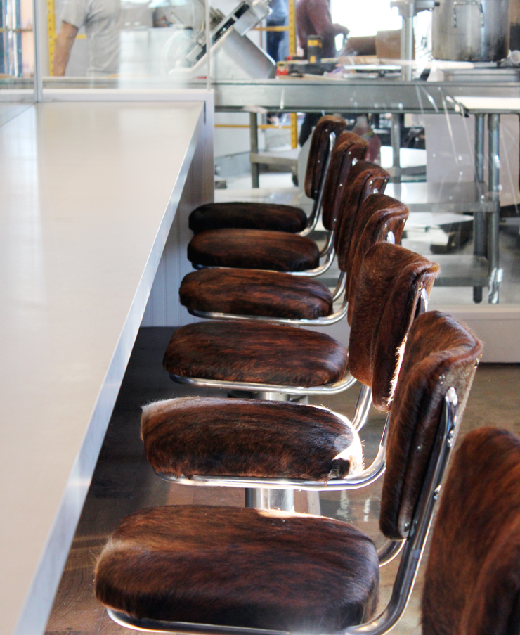 Cowhide-covered chairs at the counter.