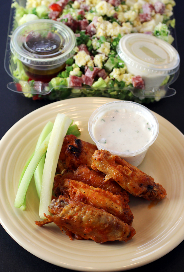 Baked spicy chicken wings (front) and the Chopped Salad (back).