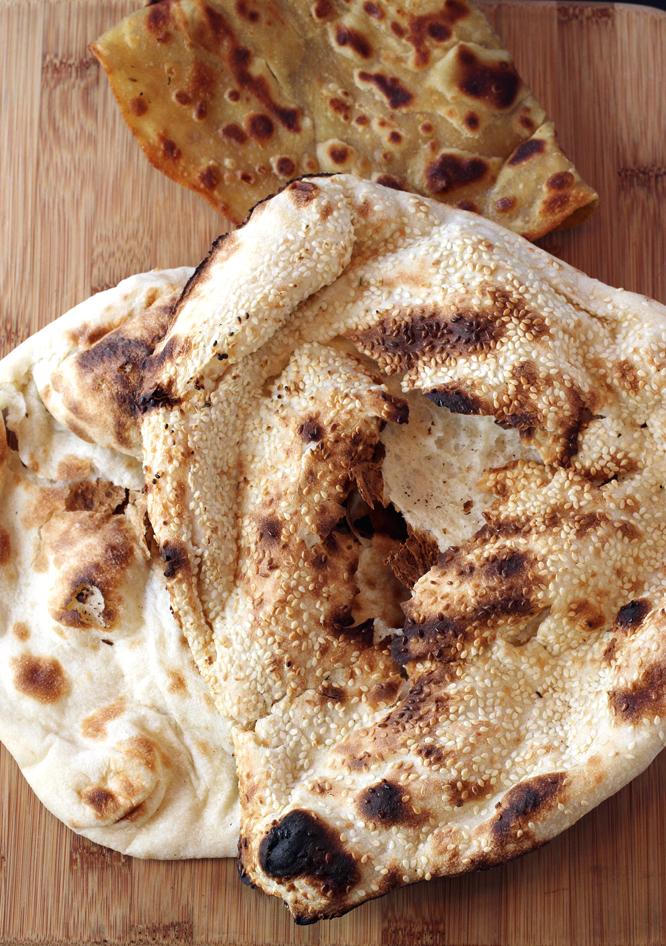 Paratha (rear), and plain and sesame naan (front).