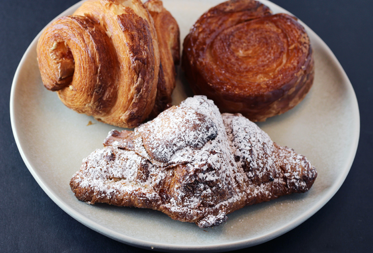 (Clockwise from top left): Ham and cheese croissiant, kouign amann, and almond croissant -- all from Arsicault.