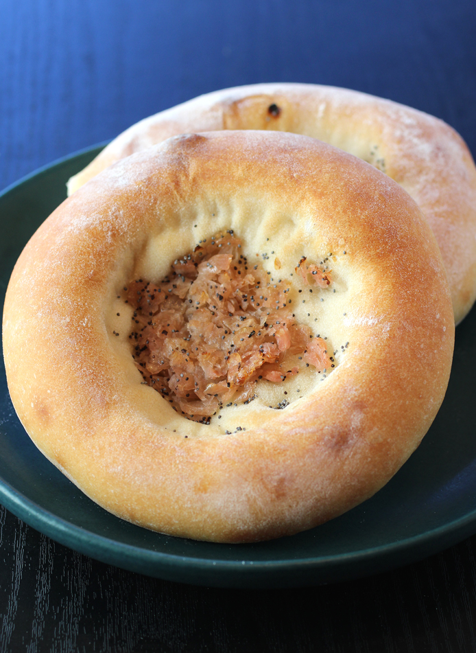 Puffy bialys filled with onions and poppy seeds.