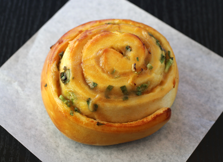 A tender roll spiraled with green onions and roasted garlic paste.