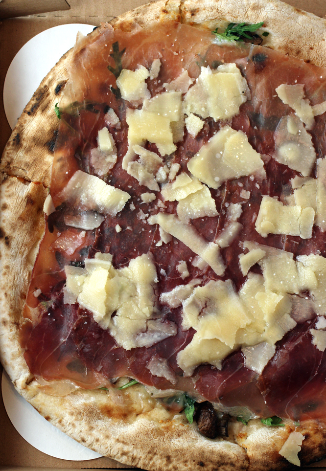 Prosciutto, aged for 24 months, is lavished over the top of this pizza.