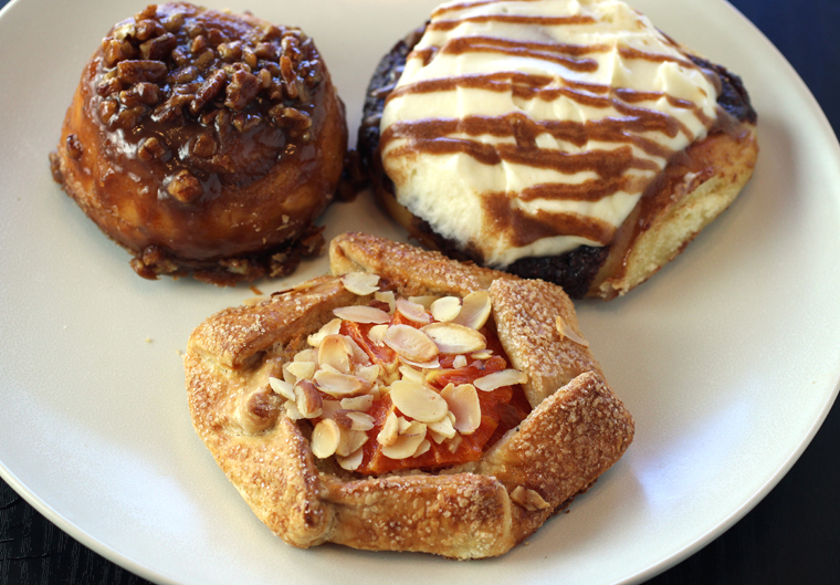 (Clockwise from top left): Morning roll, cinnamon roll, and fruit galette.