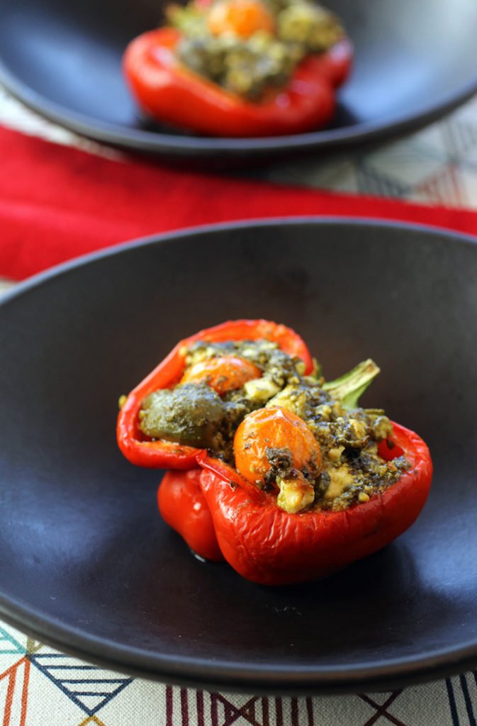 Feta, olives and pesto make up the delectable filling for these stuffed peppers.