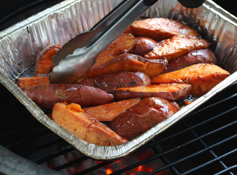 After tossing the sweet potatoes with the glaze continue grilling until the sauce reduces and coats them well.