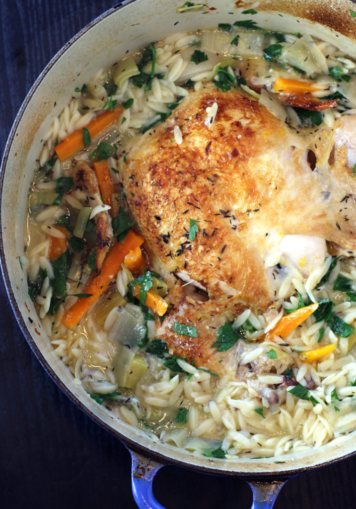 Cook a whole chicken in a big pot with veggies and orzo for an easy, one-pot meal.