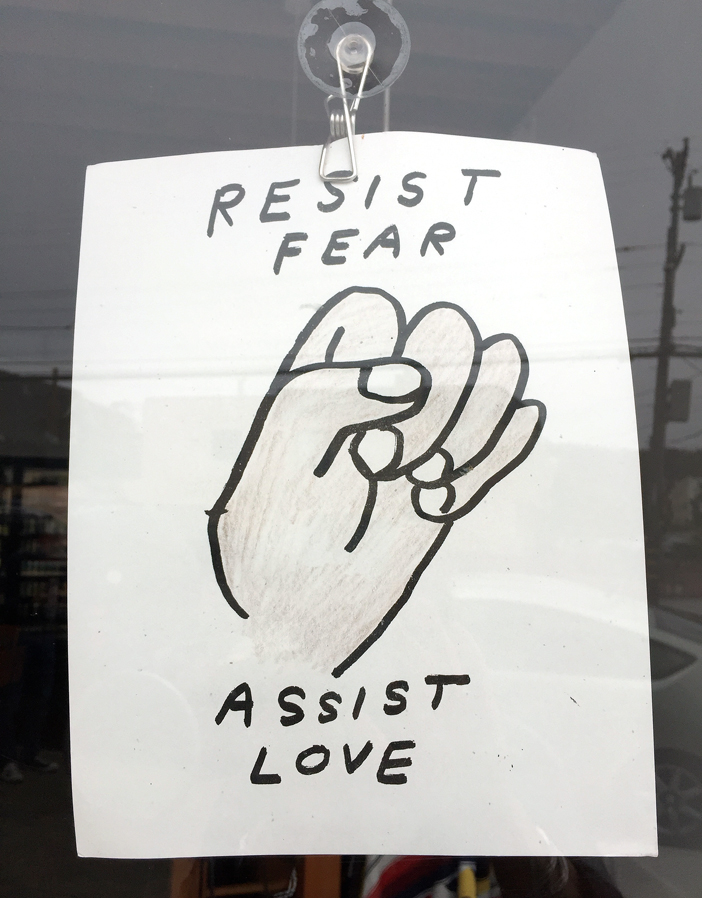A sign tacked to the window of Palm City.