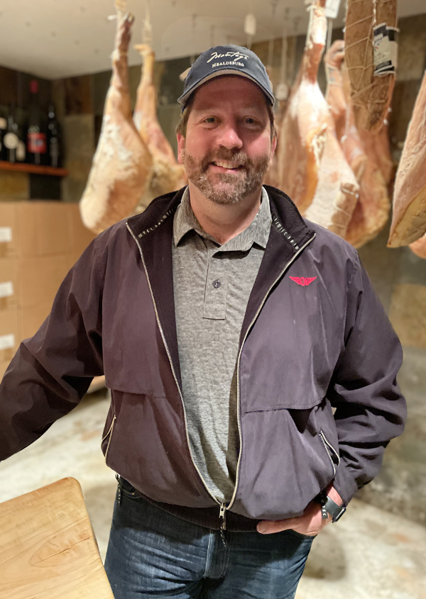 Dustin Valette in his home cellar. And yes, those are prosciutto legs in the background that he's aging.