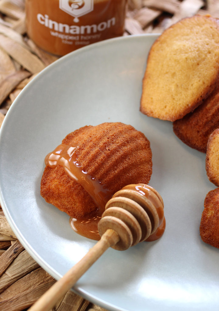 A fresh-baked batch of madeleines made with and finished with Adagio Teas Whipped Cinnamon Honey.