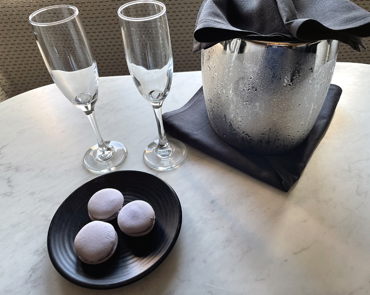 A welcoming treat of sparking wine and macarons.