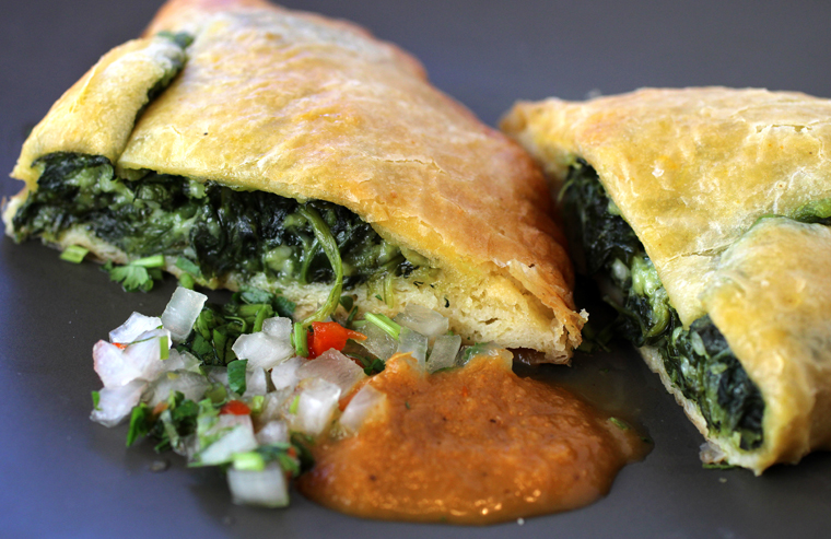Spinach and cheese empanada with sauces.
