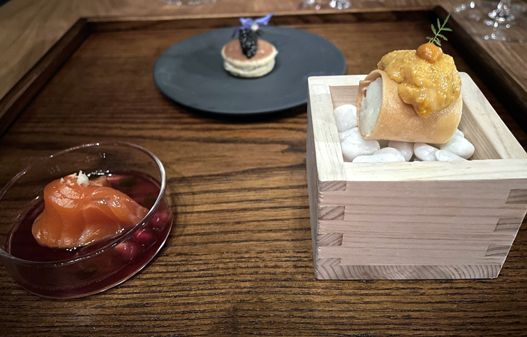 Clockwise from bottom right: potato croquette with uni, cured red trout, and doriyaki.