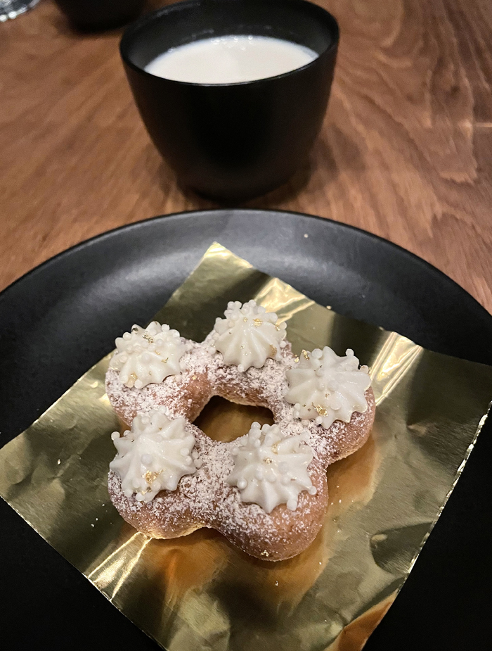 A fun mochi donut with a heavenly cup of spiked warm chestnut milk.