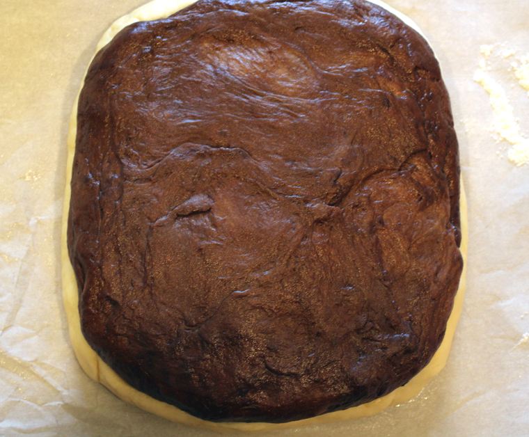 The chocolate dough on top of the filling and plain dough.