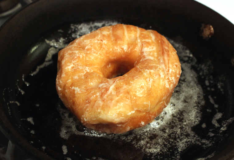 Place the doughnut in a hot pan with melted butter.
