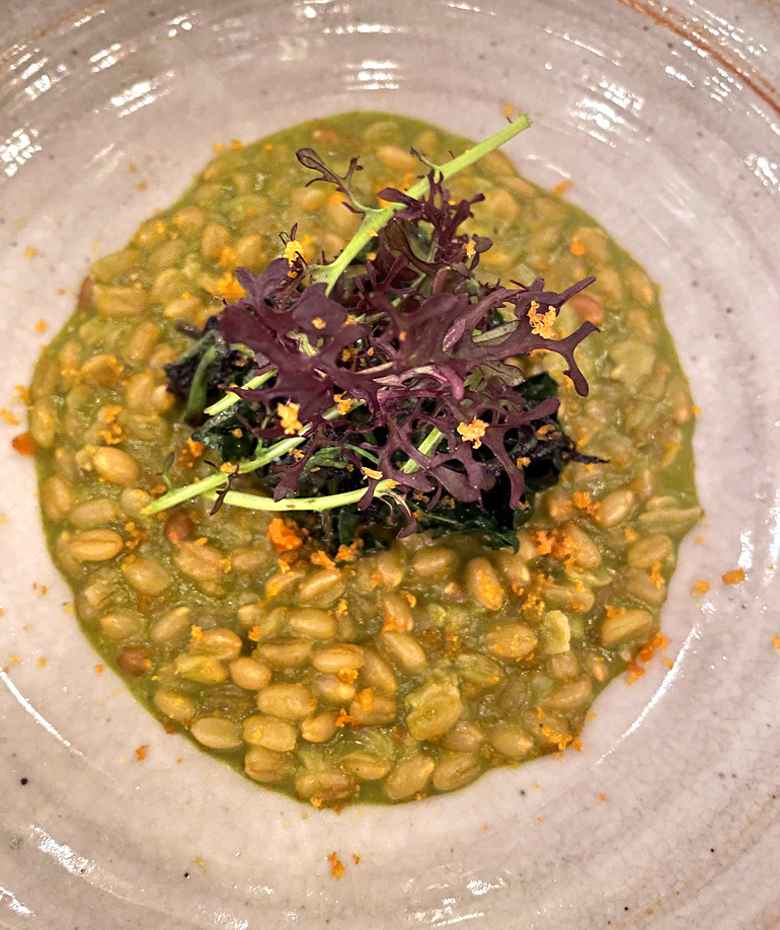 A hearty wheat berry porridge finished with mustard greens and bottarga at Mago.