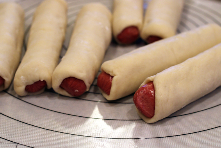 Whole hot dogs get wrapped in milk bread dough.