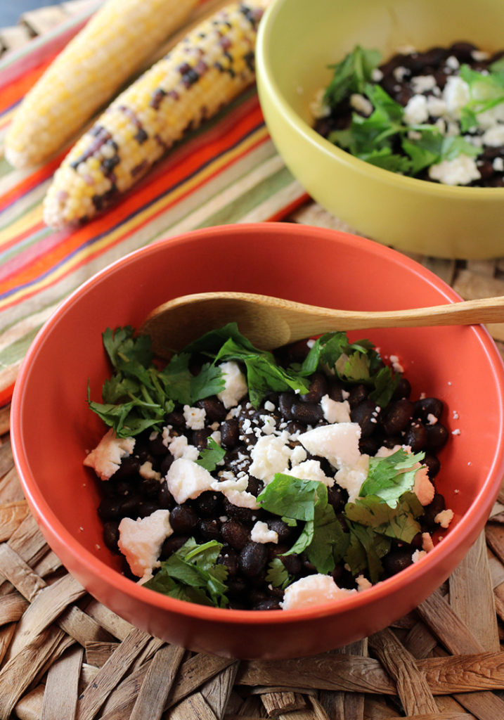 Garnished with creamy, crumbly queso fresco and cilantro, these hearty Mexican black beans can be a meal on their own with rice.
