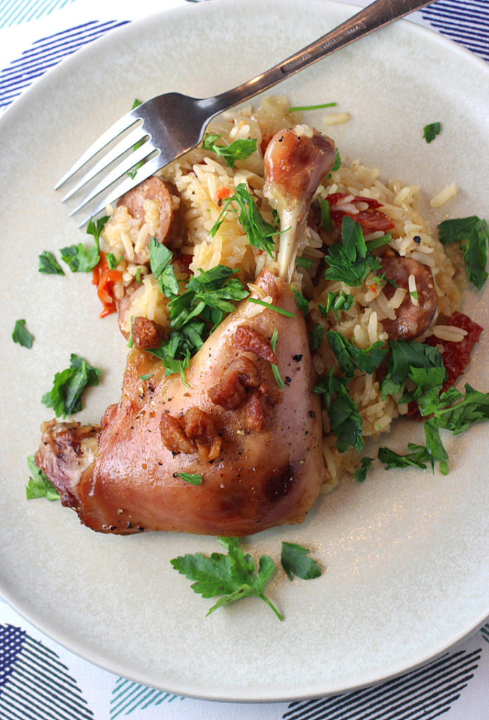 A Portuguese-inspired dish of roasted duck legs, andouille sausage and sun-dried tomato rice, all garnished with duck cracklings. 