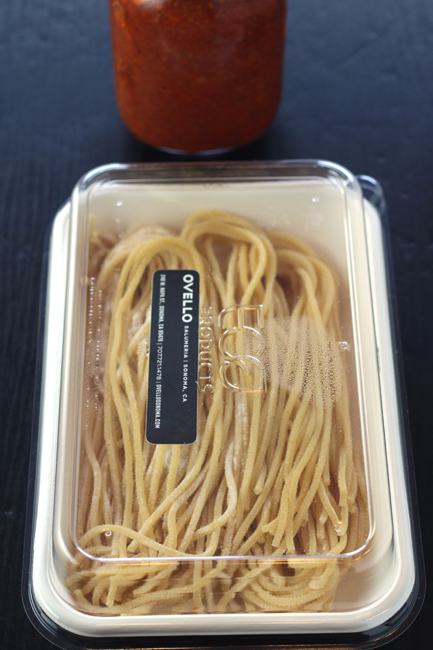 A jar of bolognese plus fresh pasta chitarra -- all made in house and ready to cook at home.
