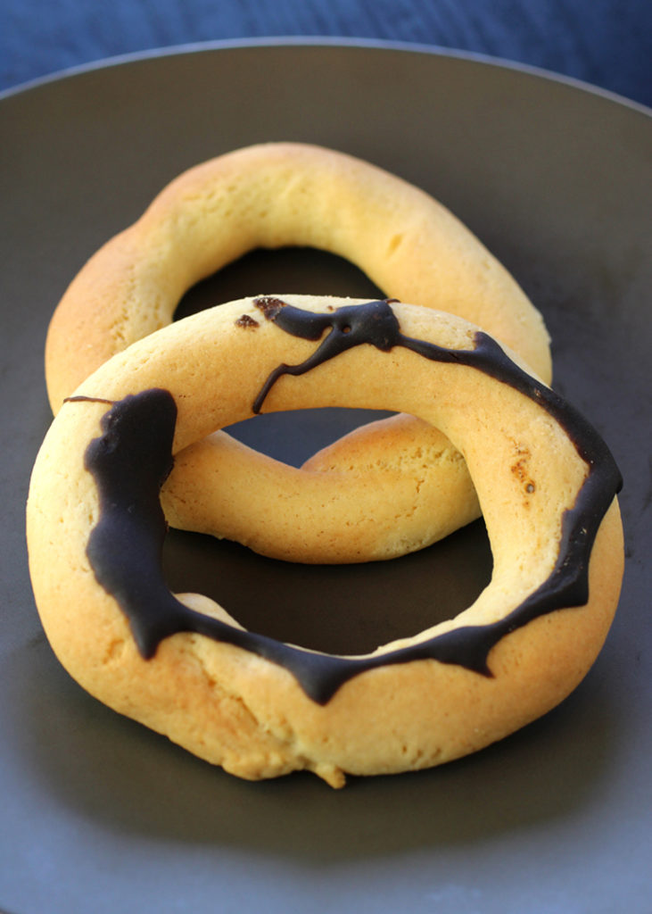 Traditional biscoitos, both plain and chocolate-glazed, from Portuguese Tasty Desserts.