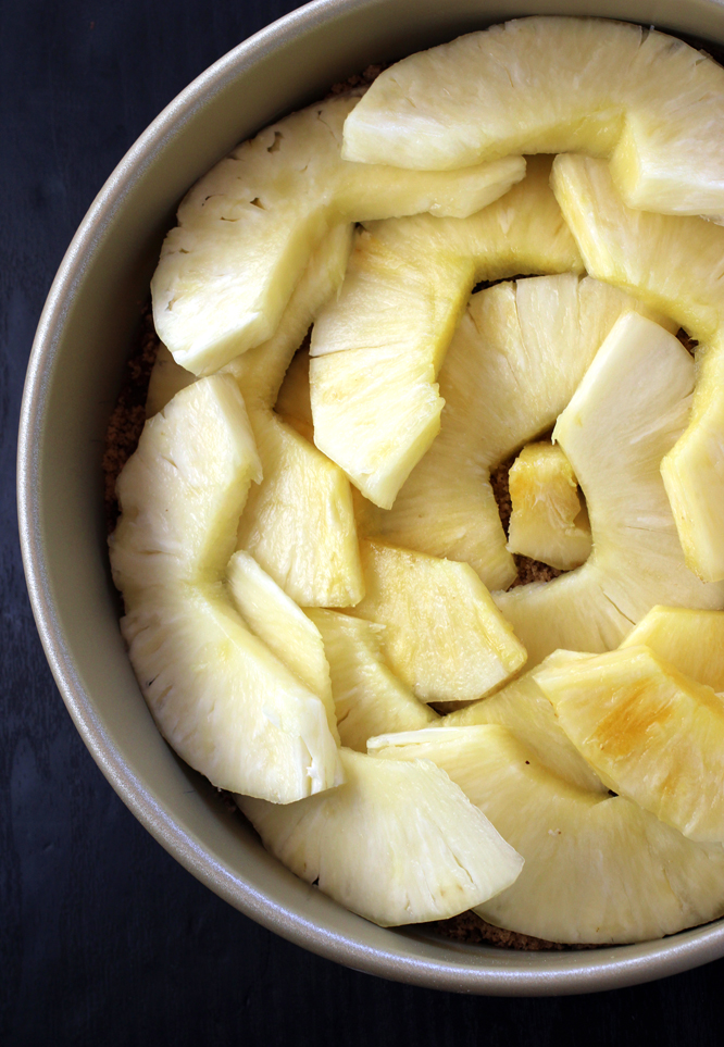 Arranging the pineapple slices in the pan.