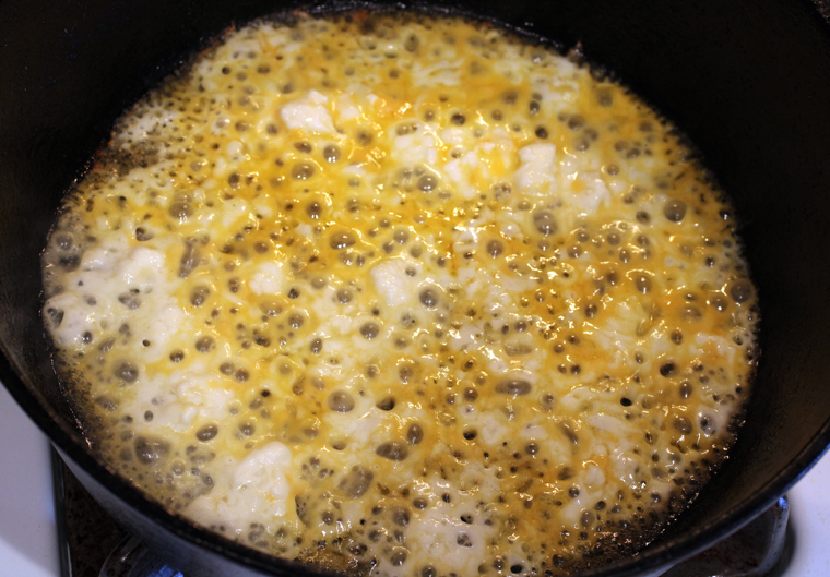 Grated cheese gets sprinkled on the bottom of the skillet.
