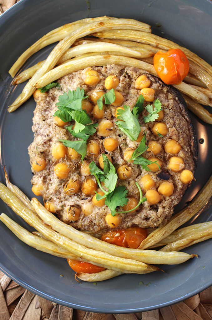 New-way stuffed mushrooms showcasing portobellos filled with hummus and chickpeas.