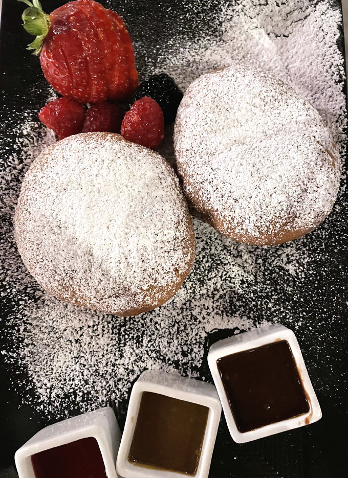 Beignets with three dipping sauces to savor.
