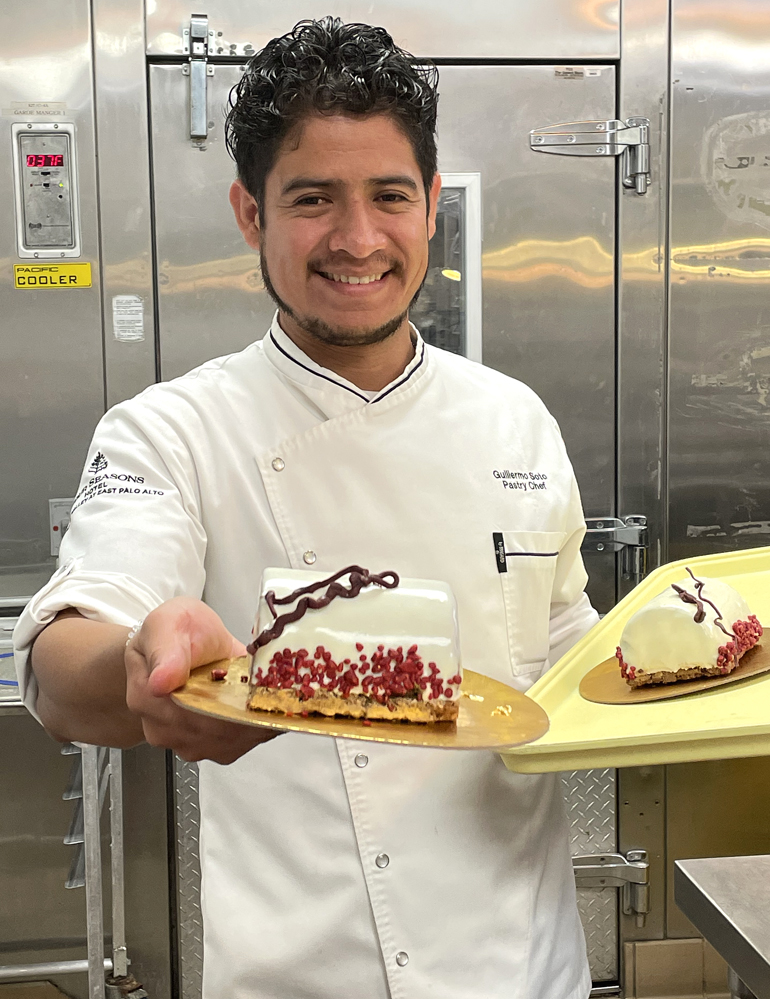 Pastry Chef Guillermo Soto Torres with mini versions of his new holiday buche de Noel.