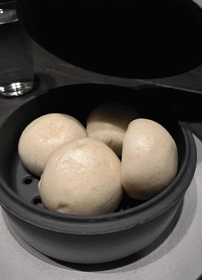 Lift the lid to find fresh, warm steamed buns.