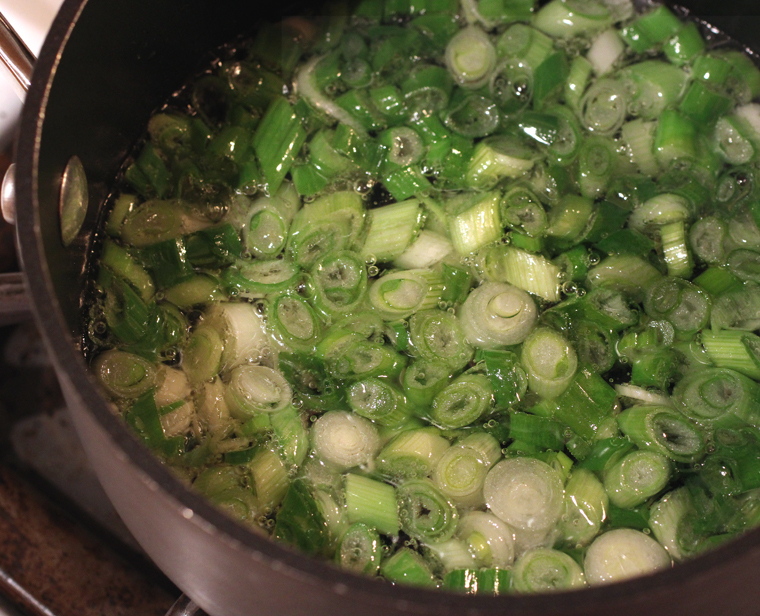 Making the scallion oil, an optional part of the recipe.