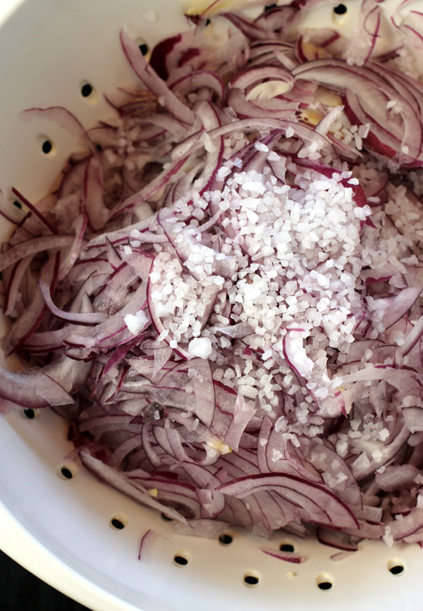 Mix coarse salt into thin slices of onion.