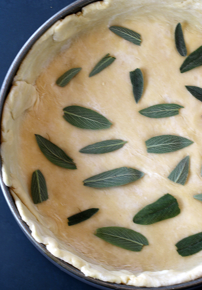 Sage leaves get pressed into the bottom and top crusts -- as well as they can.