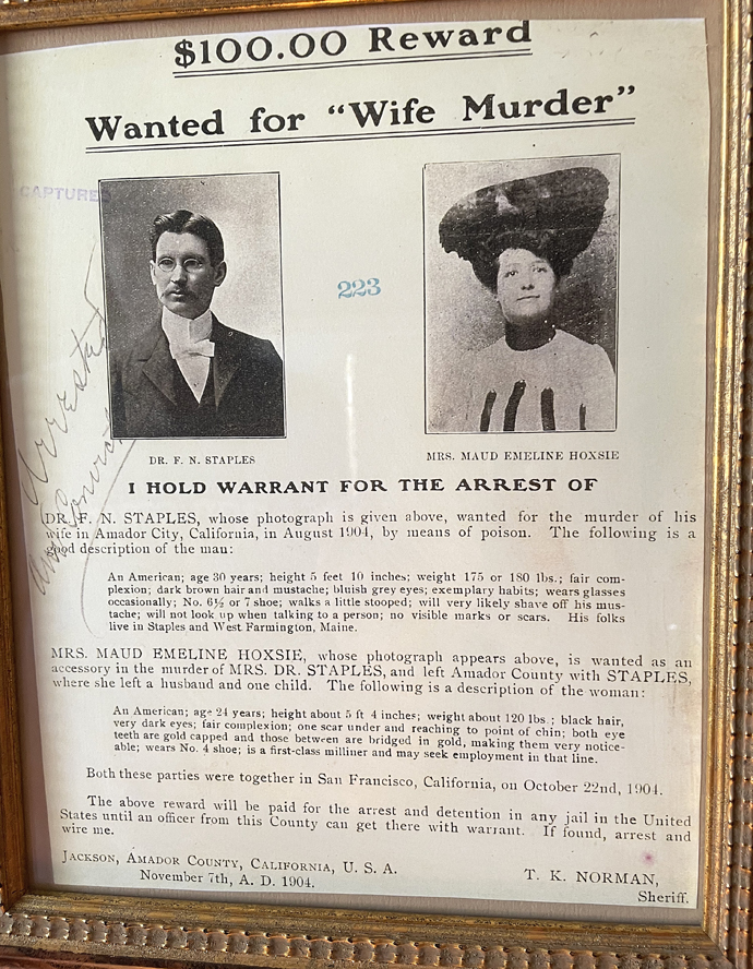 An actual framed wanted poster on the wall of the Snug.