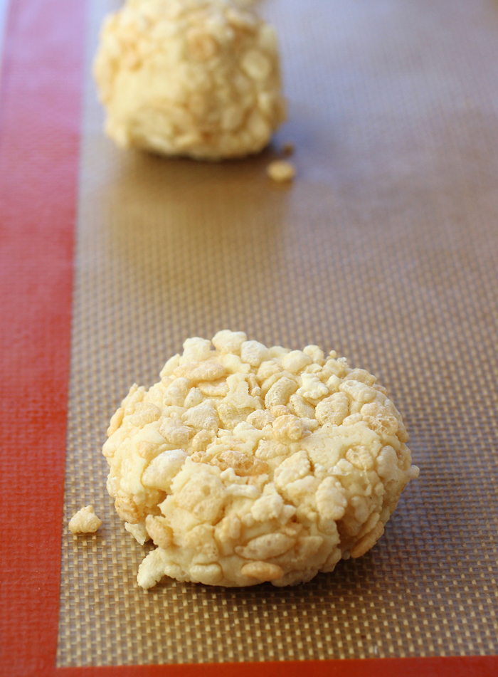 Rice Krispies are incorporated into the dough, and rolled around each cookie ball.