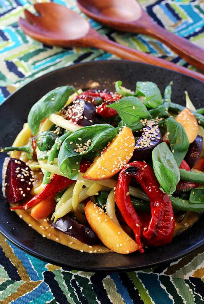 A jumble of colorful summer peppers and stone fruit star in this lively tasting salad.