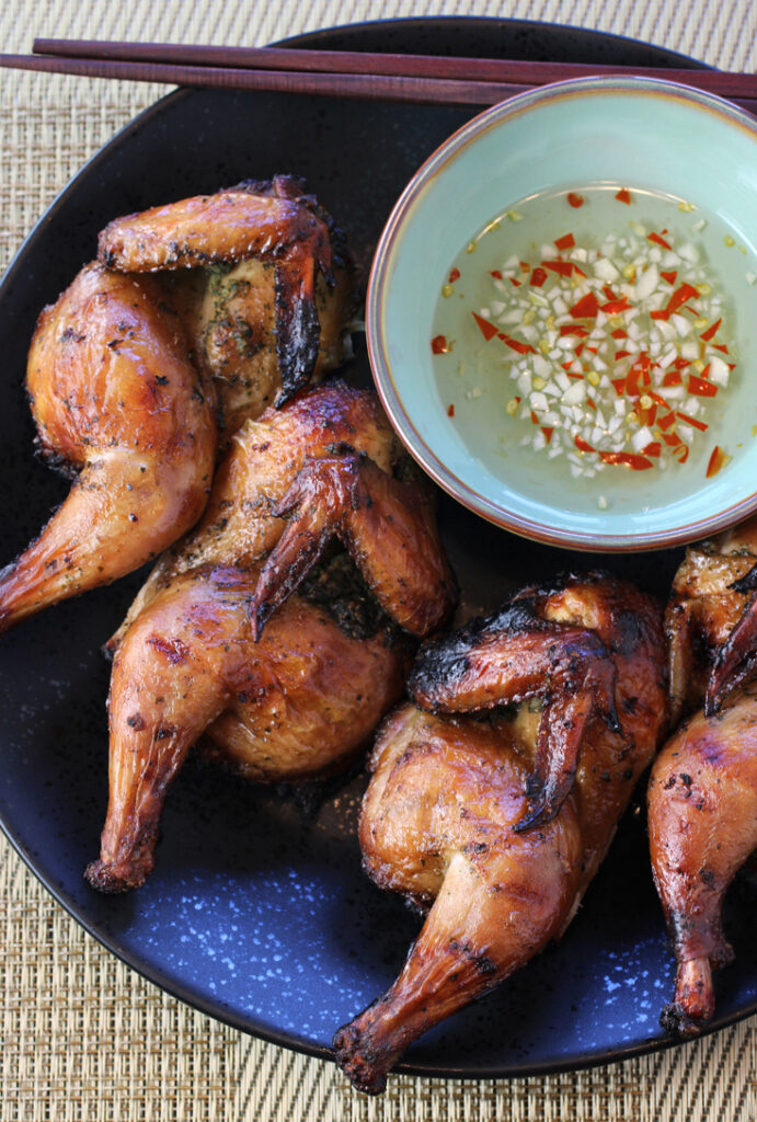A simple marinade, a toss on the grill, and an easy chile dipping sauce to finish are all that's involved in making this punchy Thai Cornish game hen dish.