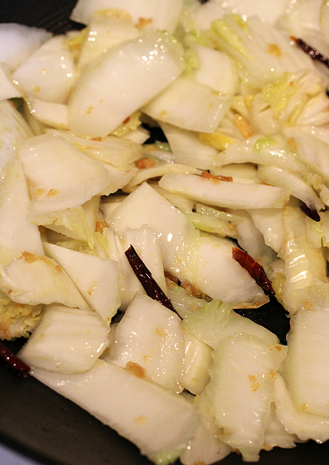 The heftier white stalks go into the pan first.