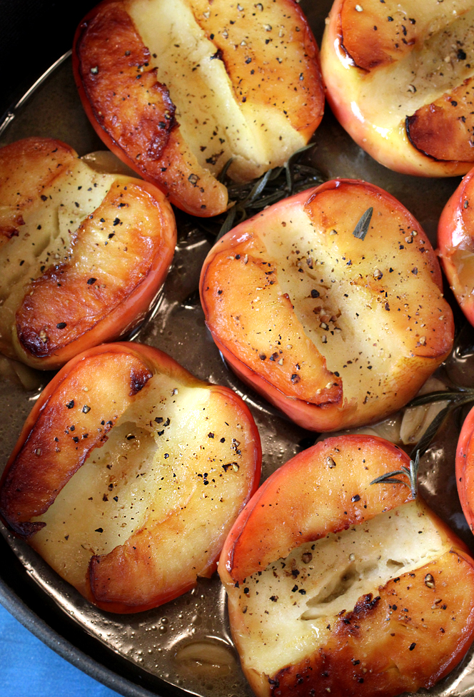 The apple halves get braised in a large pan on the stovetop.