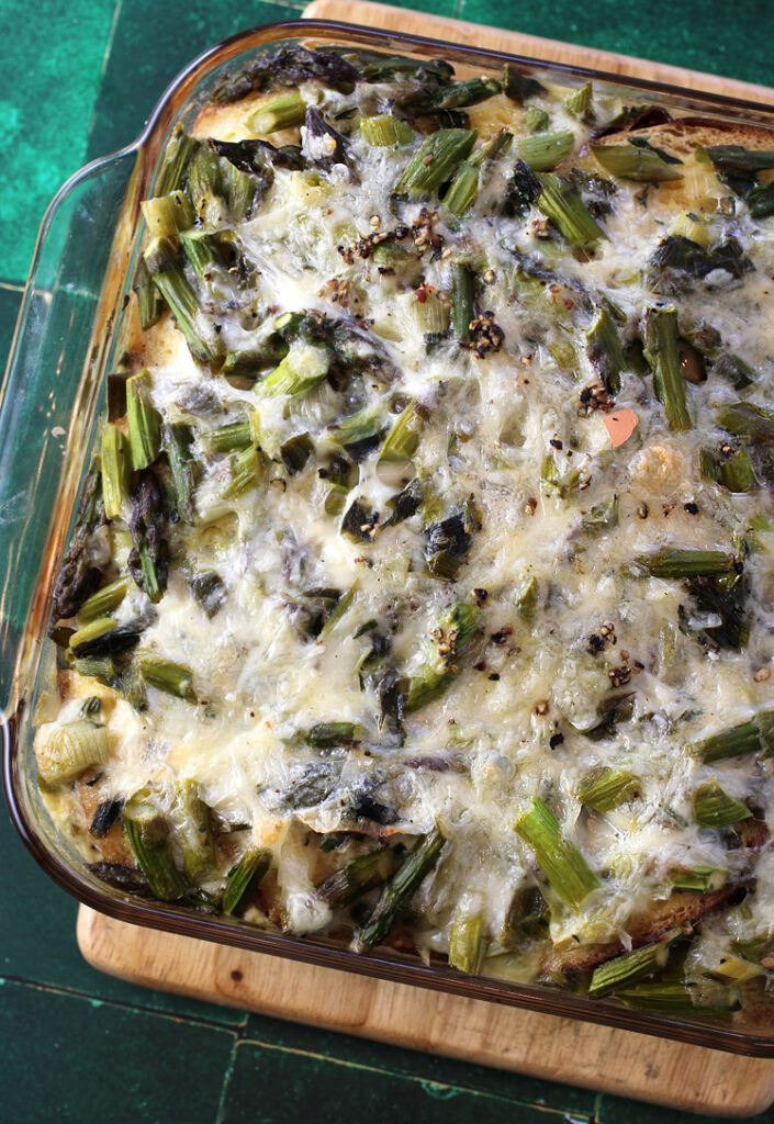 Cheesy asparagus strata with a bevy of spring onions and spring garlic.